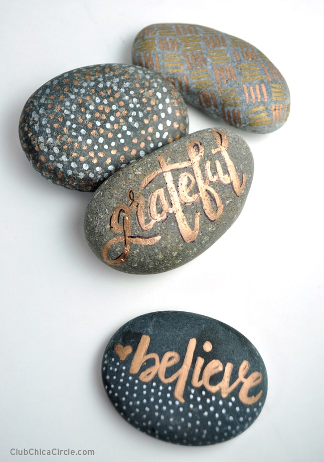 Outdoor rock decorating craft perfect for teens and tweens! Decorate rocks with metallic markers. | Easy outdoor rock crafts to take camping. | Meander & Coast #inspirationalrocks #paintedrocks #wordart #rocksforoutdoors #rockart #outdoorcrafts #teencrafts #campcrafts #camping #rockpainting